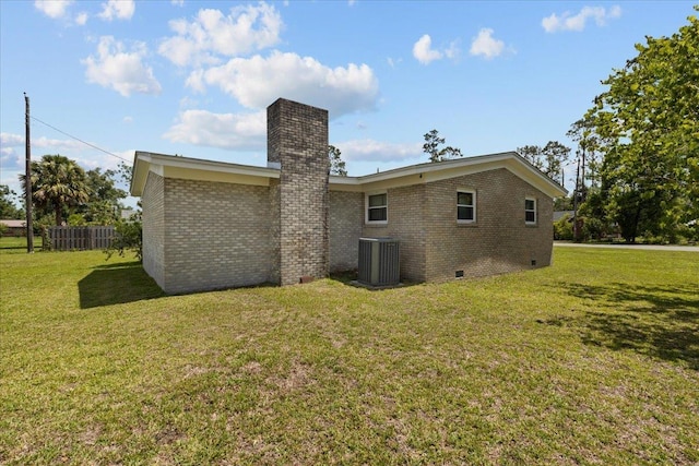 203 Forest Cir, Perry, FL 32347 - rear view of house with crawl space, brick siding, and a chimney