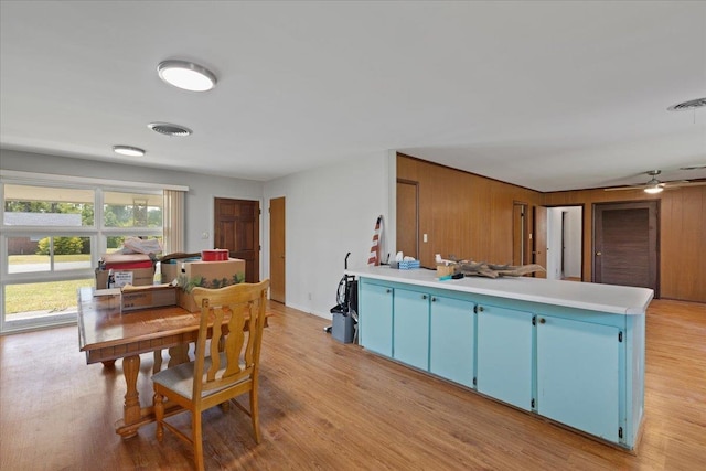 203 Forest Cir, Perry, FL 32347 - dining room with light wood-type flooring, a ceiling fan, and wood walls