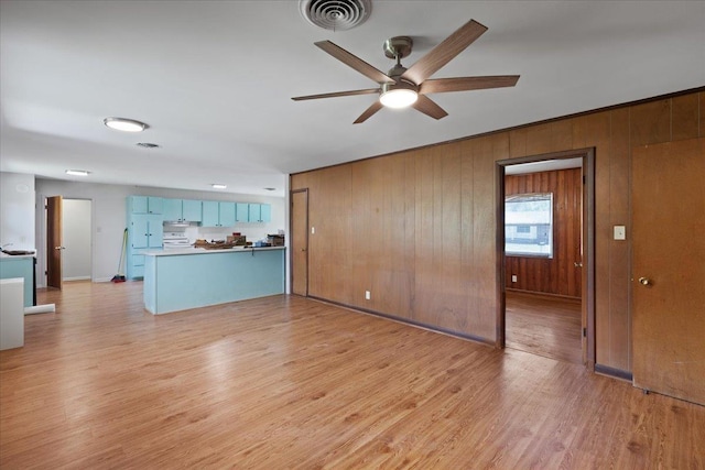 203 Forest Cir, Perry, FL 32347 - unfurnished living room featuring ceiling fan, light wood-type flooring, and wood walls