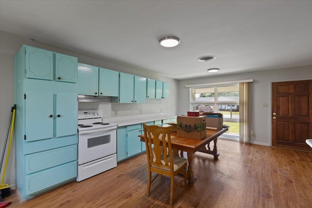 203 Forest Cir, Perry, FL 32347 - kitchen featuring white electric range, blue cabinets, dark wood-style floors, and light countertops