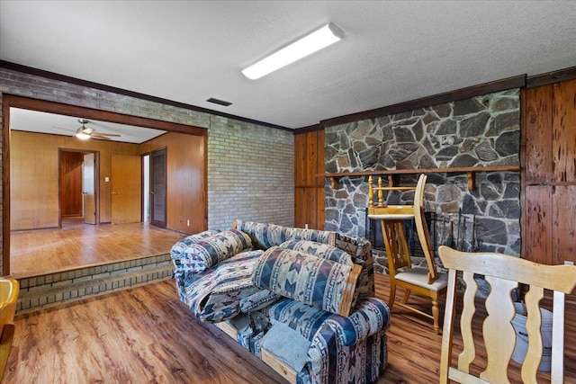 203 Forest Cir, Perry, FL 32347 - living room featuring wood finished floors, ornamental molding, a textured ceiling, and ceiling fan