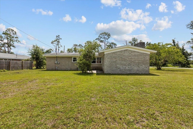 203 Forest Cir, Perry, FL 32347 - rear view of property with brick siding and a chimney
