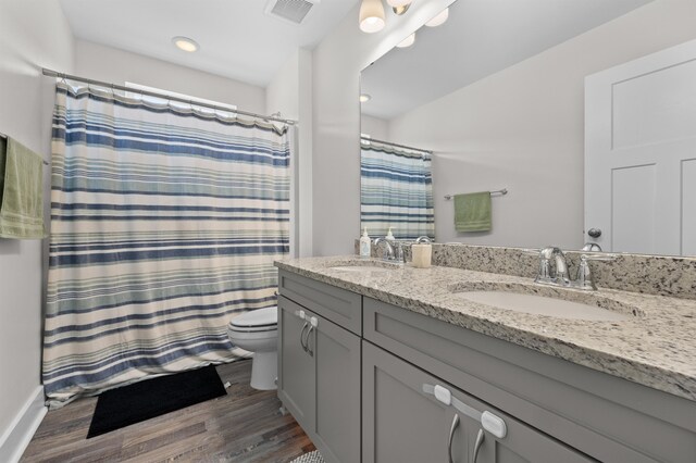 2848 Crestline Rd, Tallahassee, FL 32308 - full bathroom with double vanity, wood finished floors, curtained shower, and recessed lighting