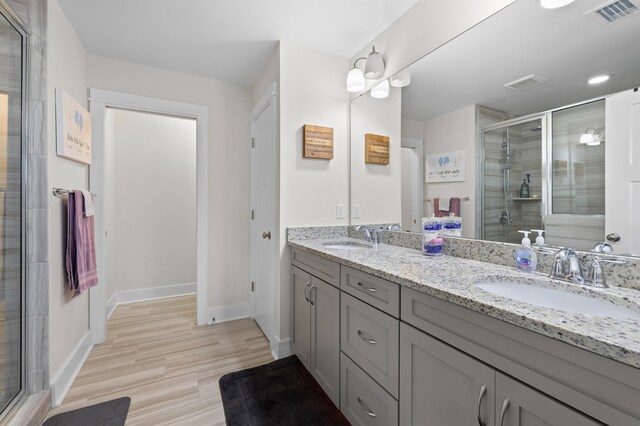 2848 Crestline Rd, Tallahassee, FL 32308 - full bathroom featuring double vanity, a stall shower, and wood finished floors