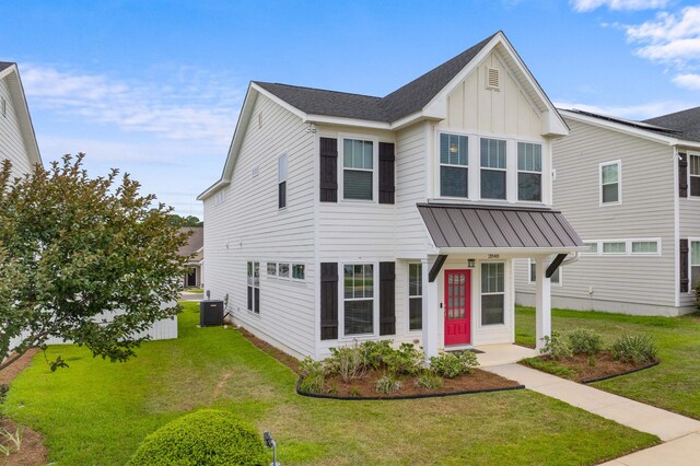 2848 Crestline Rd, Tallahassee, FL 32308 - view of front of home featuring board and batten siding, a front yard, a standing seam roof, and a metal roof