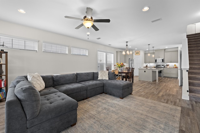 2848 Crestline Rd, Tallahassee, FL 32308 - living area featuring a ceiling fan, wood finished floors, recessed lighting, a chandelier, and stairs