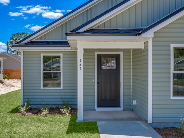 doorway to property featuring a yard