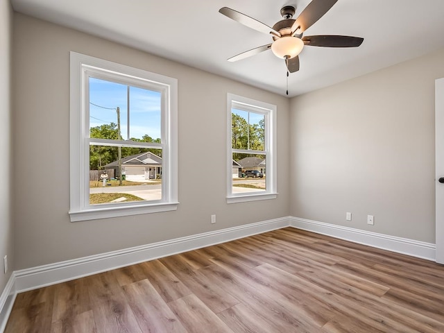 empty room with light wood-type flooring, plenty of natural light, and ceiling fan