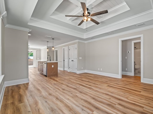 unfurnished living room with crown molding, a raised ceiling, sink, ceiling fan, and light hardwood / wood-style flooring