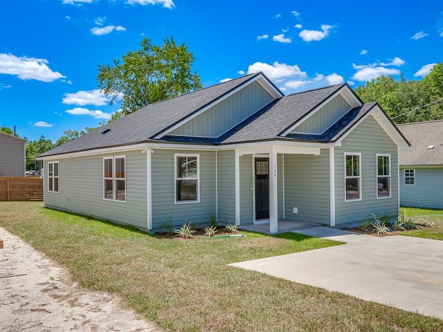 view of front of home featuring a front lawn and a patio