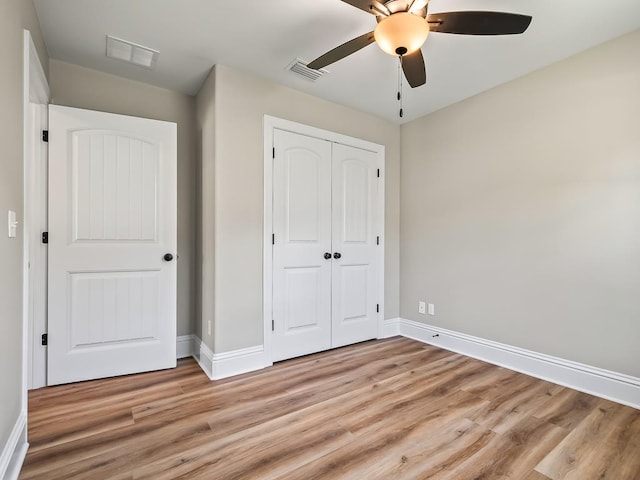 unfurnished bedroom with a closet, ceiling fan, and light hardwood / wood-style flooring