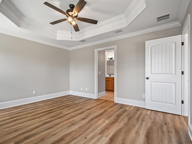 unfurnished bedroom with ornamental molding, hardwood / wood-style flooring, and ceiling fan