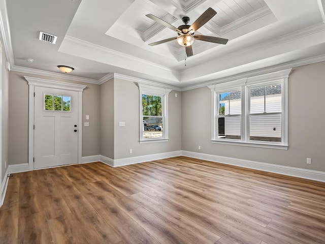 foyer with a tray ceiling, hardwood / wood-style flooring, ceiling fan, and crown molding