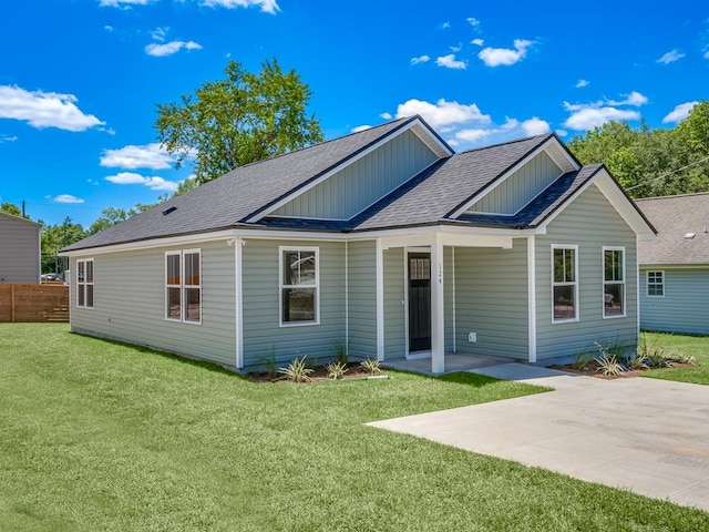 rear view of property featuring a patio area and a yard