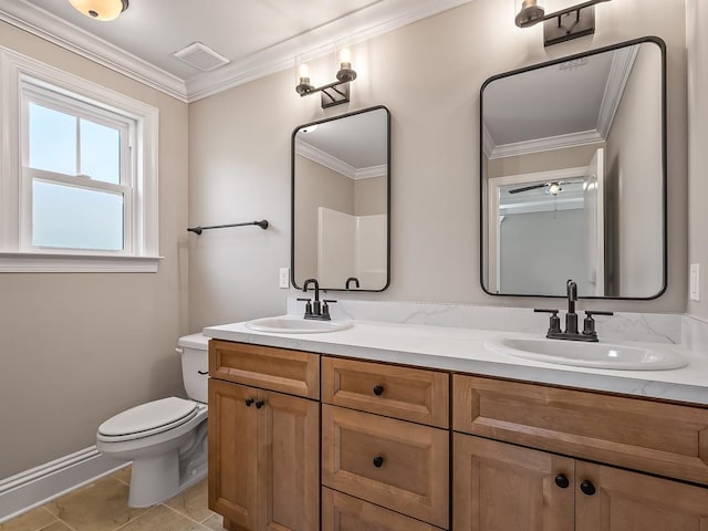 bathroom with tile patterned floors, vanity, toilet, and crown molding