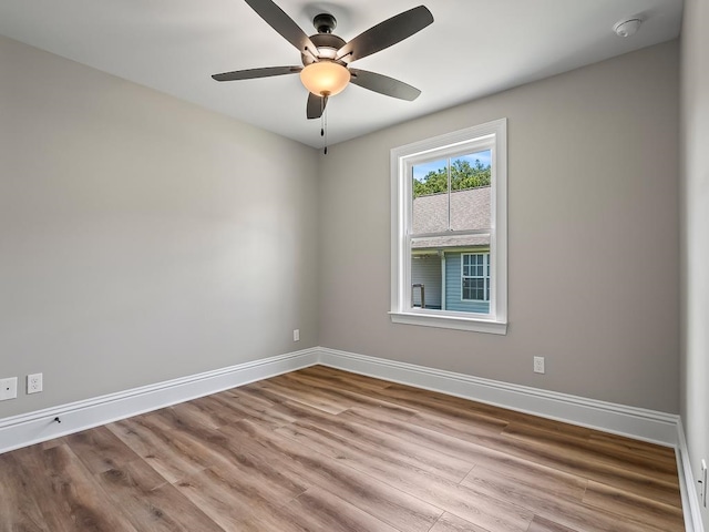 empty room with light hardwood / wood-style floors and ceiling fan