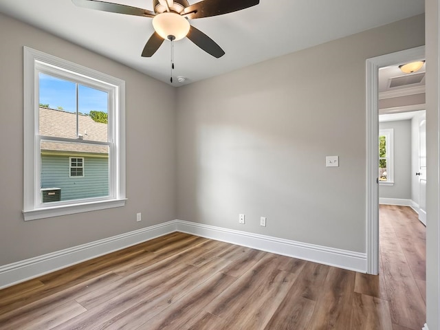 unfurnished room featuring ceiling fan, light hardwood / wood-style flooring, and ornamental molding