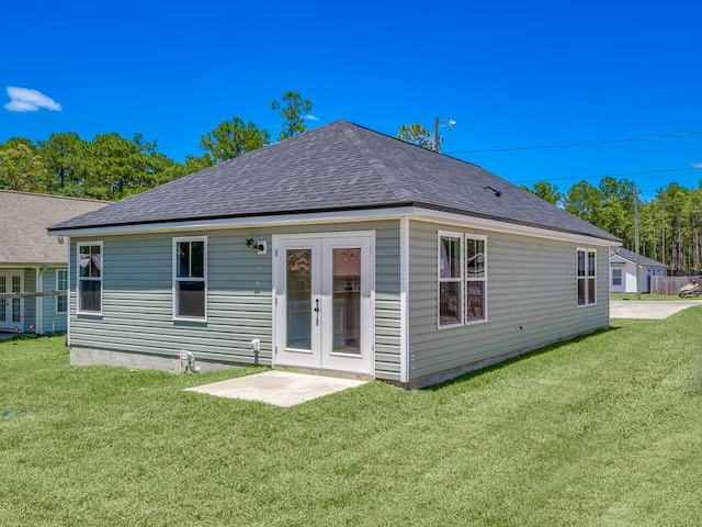 rear view of house featuring a yard and french doors