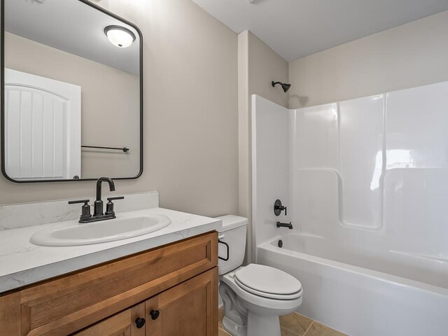 full bathroom featuring toilet, tub / shower combination, vanity, and tile patterned floors