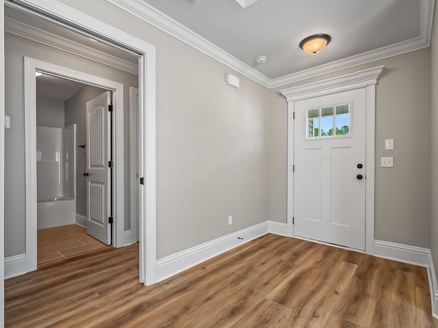 entryway featuring ornamental molding and wood-type flooring