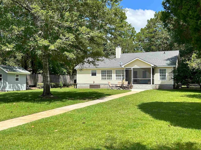 ranch-style home with a sunroom and a front lawn