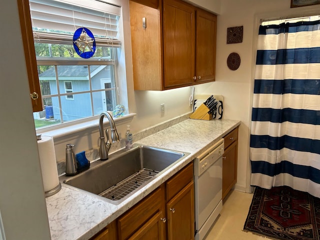 kitchen with dishwasher, a healthy amount of sunlight, and sink