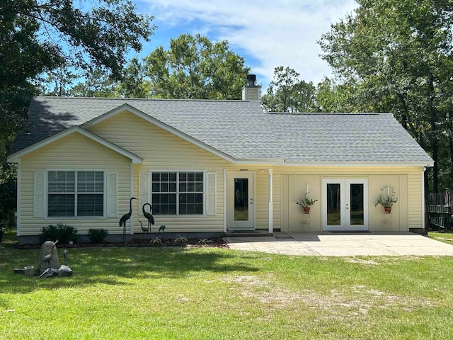 back of property featuring french doors, a yard, and a patio area