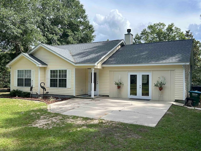 rear view of property with a yard and a patio area