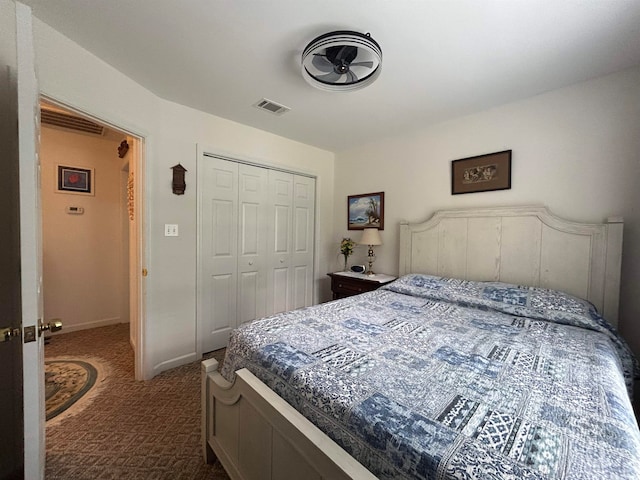 bedroom featuring a closet and dark carpet