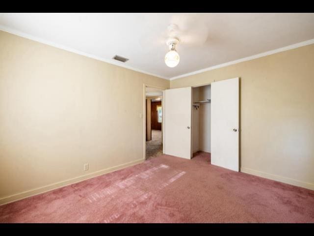 10168 NE Colin Kelly Hwy, Pinetta Madison County, FL 32350 - unfurnished bedroom with ornamental molding, light carpet, baseboards, and a closet