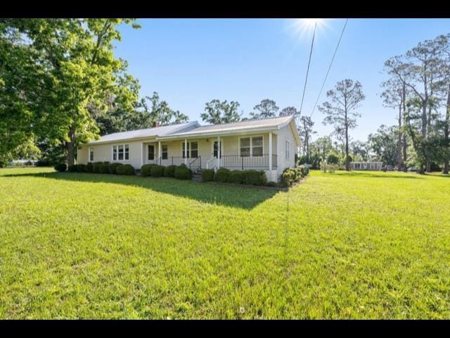 10168 NE Colin Kelly Hwy, Pinetta Madison County, FL 32350 - view of front of home featuring covered porch and a front lawn