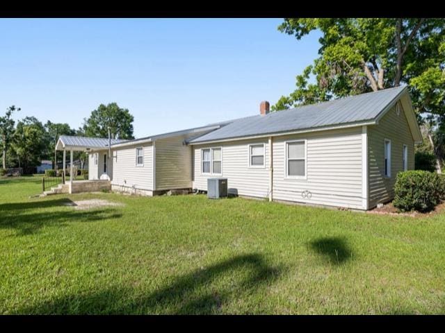 10168 NE Colin Kelly Hwy, Pinetta Madison County, FL 32350 - rear view of property featuring central AC unit and a lawn