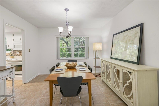 3822 Leane Dr, Tallahassee, FL 32309 - dining space featuring a chandelier, baseboards, and light tile patterned floors