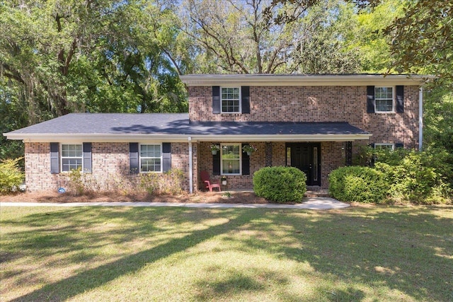 3822 Leane Dr, Tallahassee, FL 32309 - traditional home featuring a front lawn, brick siding, and a porch