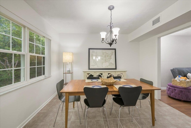 3822 Leane Dr, Tallahassee, FL 32309 - dining space with a chandelier and baseboards