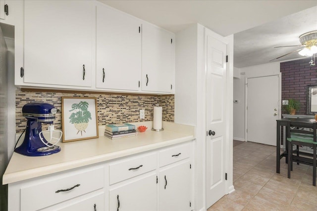 3822 Leane Dr, Tallahassee, FL 32309 - kitchen with ceiling fan, light countertops, white cabinets, and tasteful backsplash