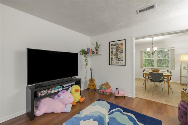 3822 Leane Dr, Tallahassee, FL 32309 - living area featuring wood finished floors, baseboards, and a chandelier