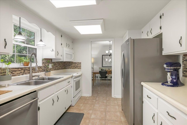 3822 Leane Dr, Tallahassee, FL 32309 - kitchen featuring stainless steel appliances, a sink, backsplash, and white cabinets