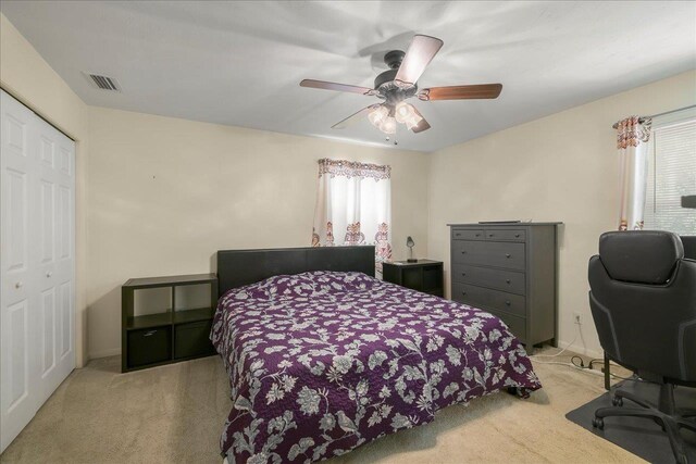 3822 Leane Dr, Tallahassee, FL 32309 - bedroom with light colored carpet, a ceiling fan, and a closet