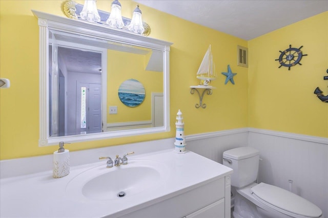 3822 Leane Dr, Tallahassee, FL 32309 - half bathroom with toilet, wainscoting, and vanity