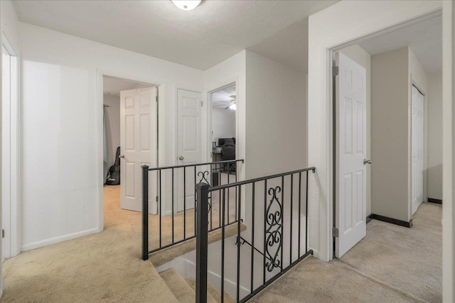 3822 Leane Dr, Tallahassee, FL 32309 - corridor featuring an upstairs landing, light colored carpet, and baseboards