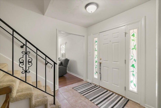 3822 Leane Dr, Tallahassee, FL 32309 - tiled foyer featuring stairs and baseboards