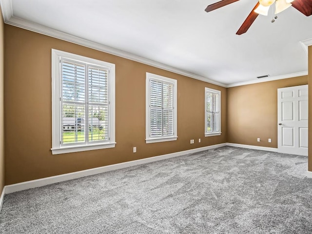 carpeted spare room featuring ceiling fan and crown molding