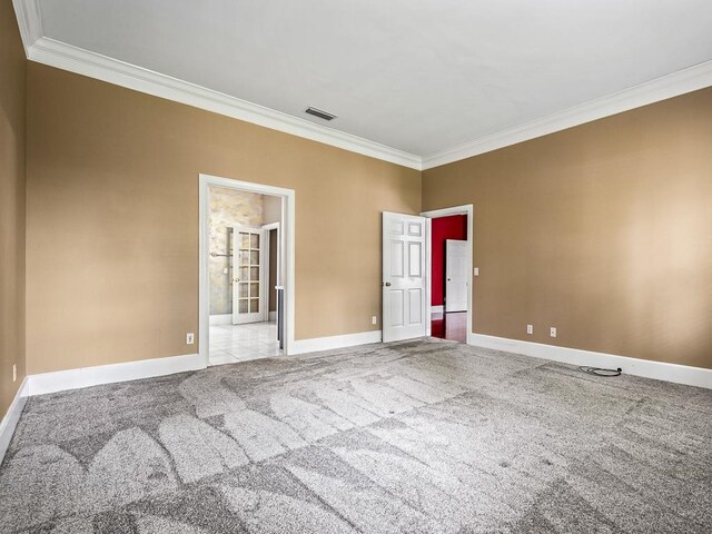 carpeted spare room featuring crown molding