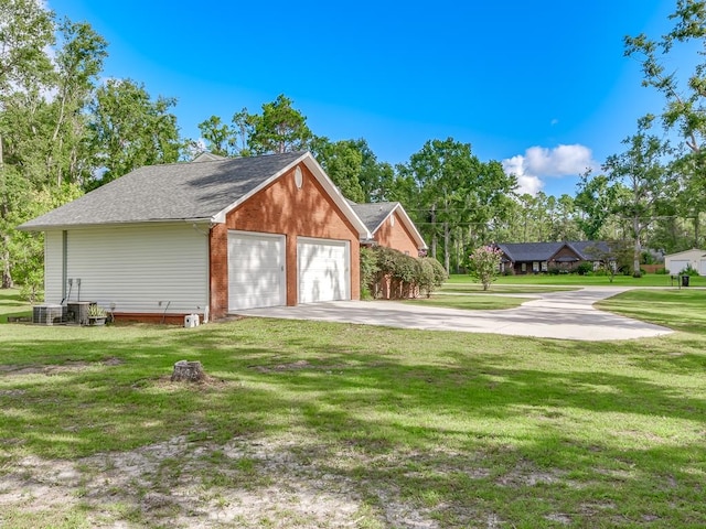 garage with a lawn and cooling unit