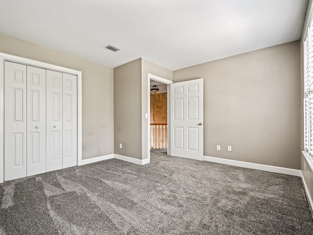 unfurnished bedroom with a closet and carpet