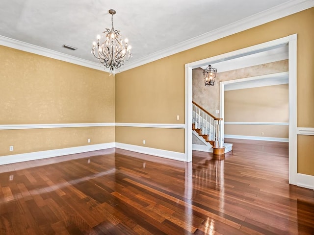 unfurnished room featuring ornamental molding, a chandelier, and dark hardwood / wood-style floors