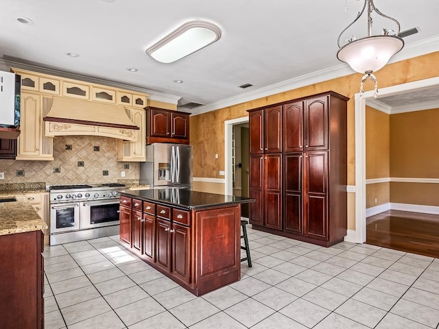 kitchen with tasteful backsplash, crown molding, appliances with stainless steel finishes, custom range hood, and dark stone countertops