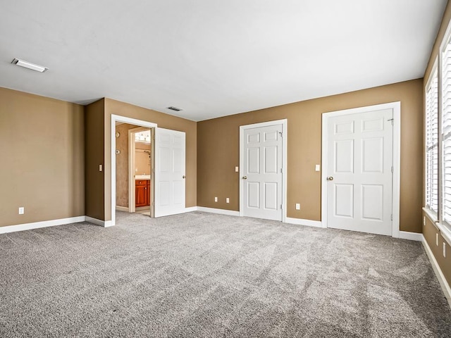 127 Bullen Ln, Perry, FL 32347 - unfurnished bedroom featuring carpet floors, baseboards, and ensuite bathroom