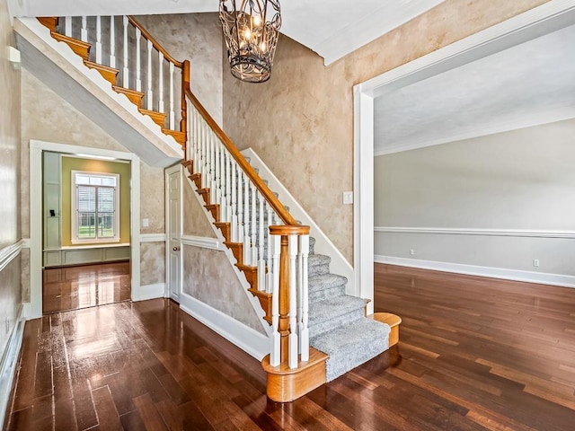 127 Bullen Ln, Perry, FL 32347 - staircase featuring hardwood / wood-style floors, baseboards, and a chandelier
